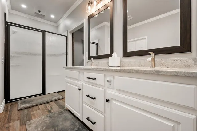 a bathroom with a granite countertop sink toilet a mirror and shower