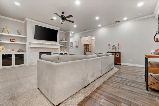a living room with couches and a large mirror with wooden floor