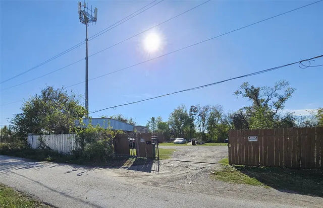 a view of street along with wooden fence
