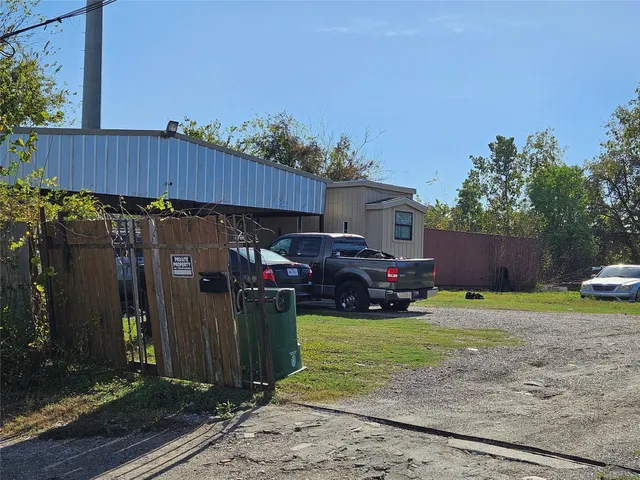 a view of a house with a yard and sitting area