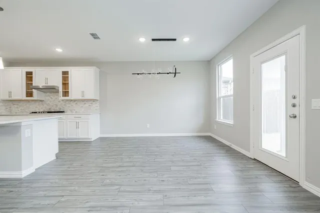 a view of granite countertop kitchen island a sink dishwasher and a refrigerator