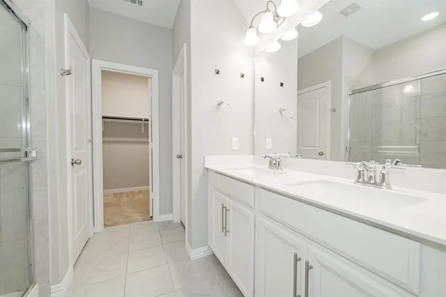 a bathroom with double sink and a mirror