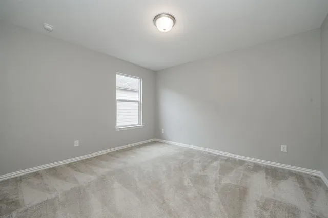a bathroom with a sink a toilet a mirror and shower
