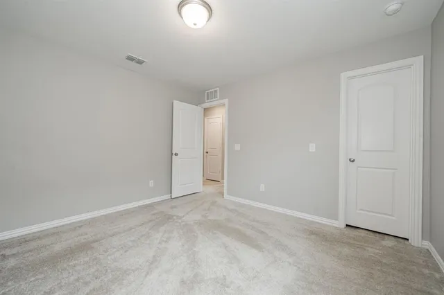 a view of a large house with a big yard and large trees