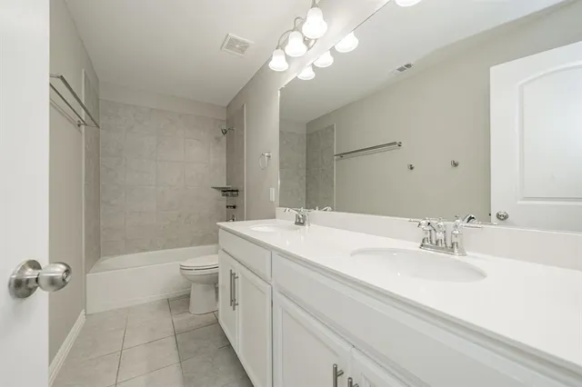 a view of a house with backyard and wooden fence