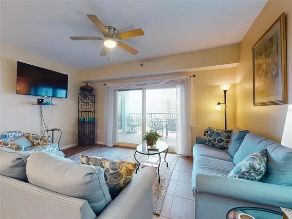 a living room with furniture and a chandelier