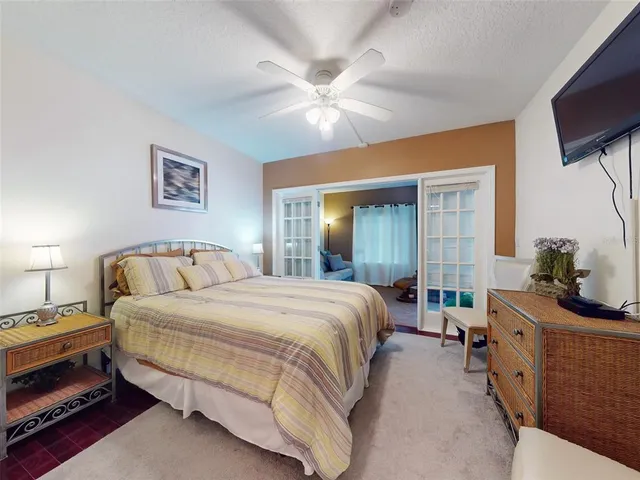 a bedroom with a large bed and a chandelier