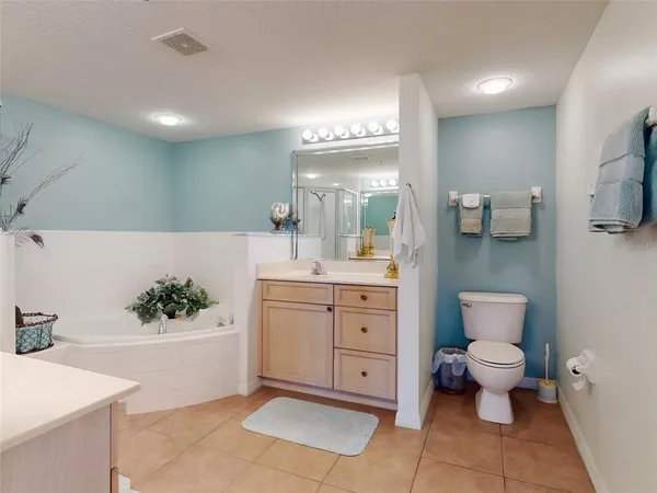 a bathroom with a shower sink and mirror