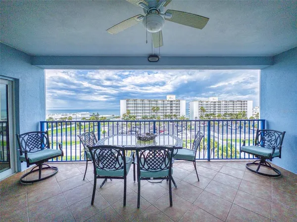 a view of a swimming pool and outdoor seating
