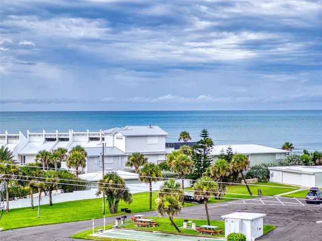 a front view of a residential apartment building with a yard