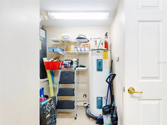 a view of a hallway with wooden floor and a view of bathroom