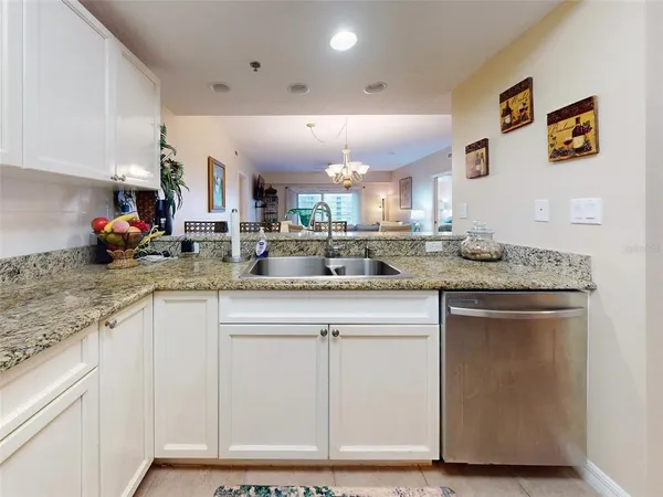 a kitchen with sink and chandelier