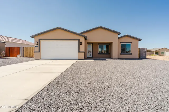 a view of a house with a yard and garage