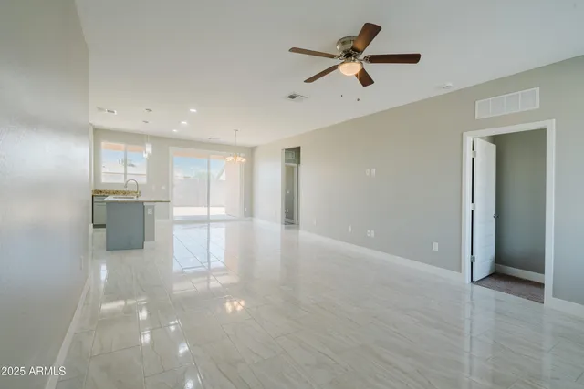 a large white kitchen with a refrigerator a stove and a sink