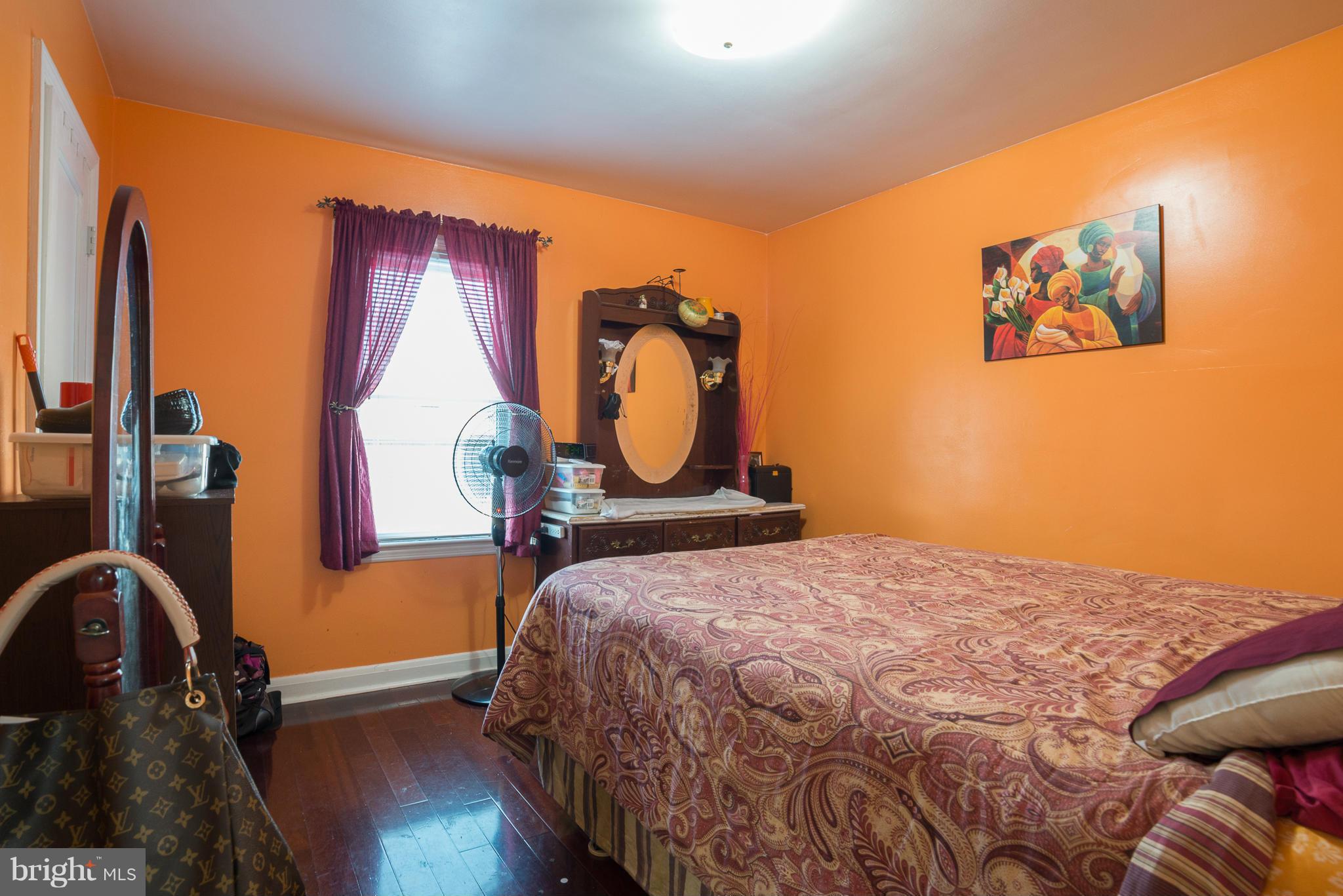 5314 Overhill Road Baltimore, MD 21207 - Photo 13 of 14 a bedroom with a bed and a dresser