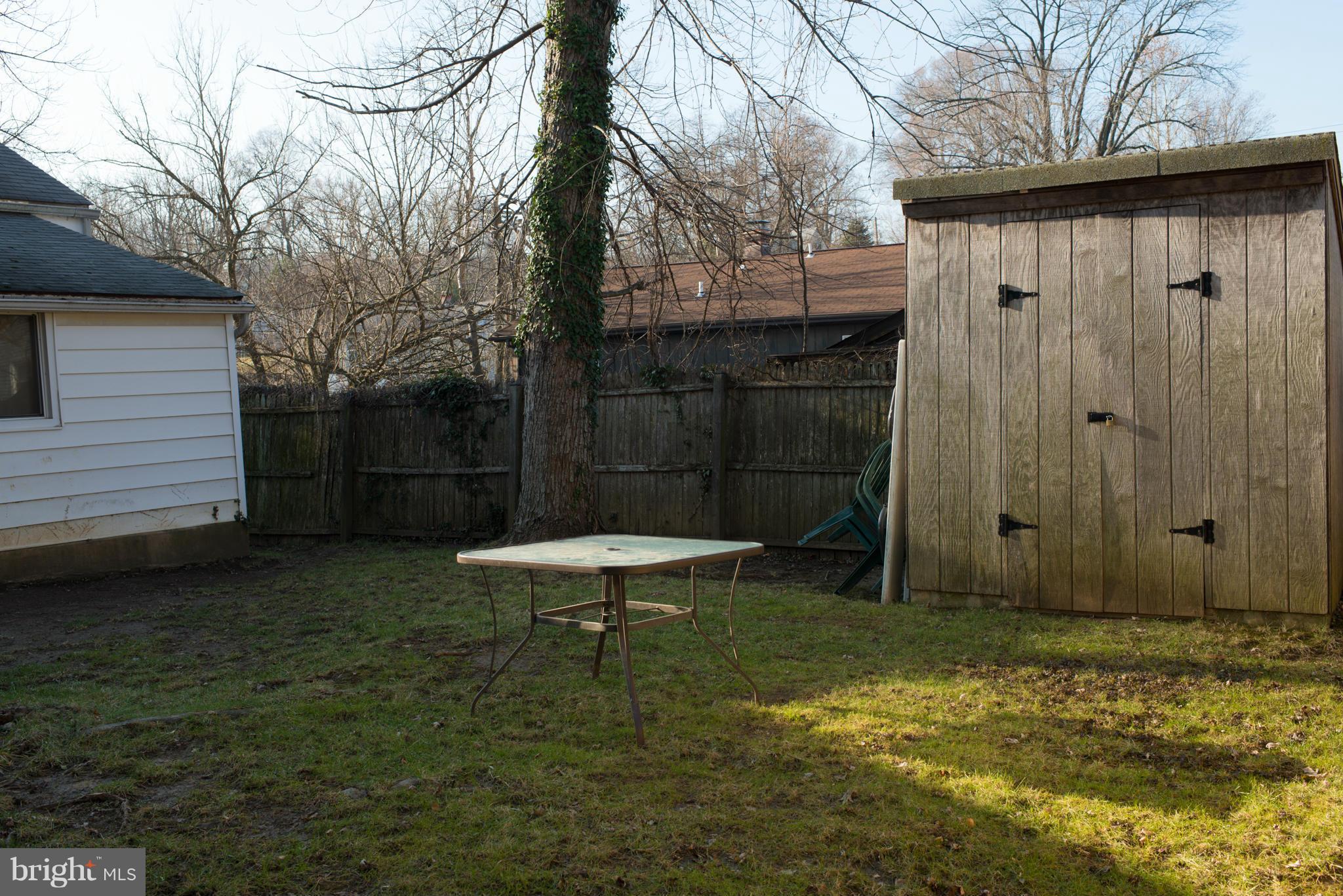 5314 Overhill Road Baltimore, MD 21207 - Photo 3 of 14 a view of a backyard with a small cabin and a chair