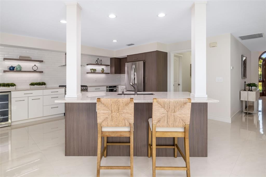 480 Cleveland Drive Sarasota, FL 34236 - Photo 13 of 95 a kitchen with kitchen island granite countertop wooden cabinets and counter space