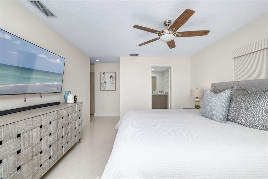 480 Cleveland Drive Sarasota, FL 34236 - Photo 33 of 95 a bedroom with a large bed and a flat tv screen on dresser