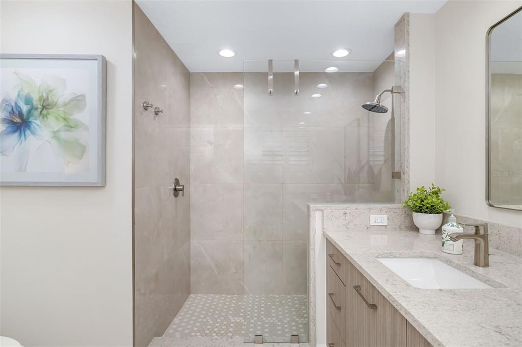 480 Cleveland Drive Sarasota, FL 34236 - Photo 36 of 95 a bathroom with a granite countertop sink a mirror and a shower
