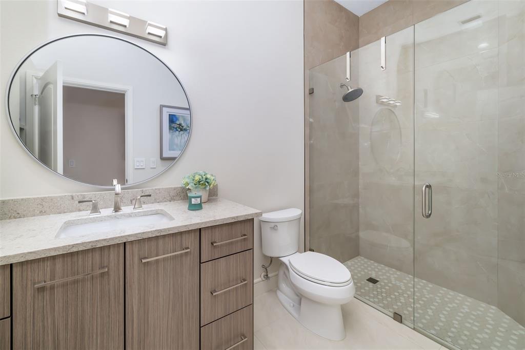 480 Cleveland Drive Sarasota, FL 34236 - Photo 44 of 95 a bathroom with a toilet a sink a mirror and shower