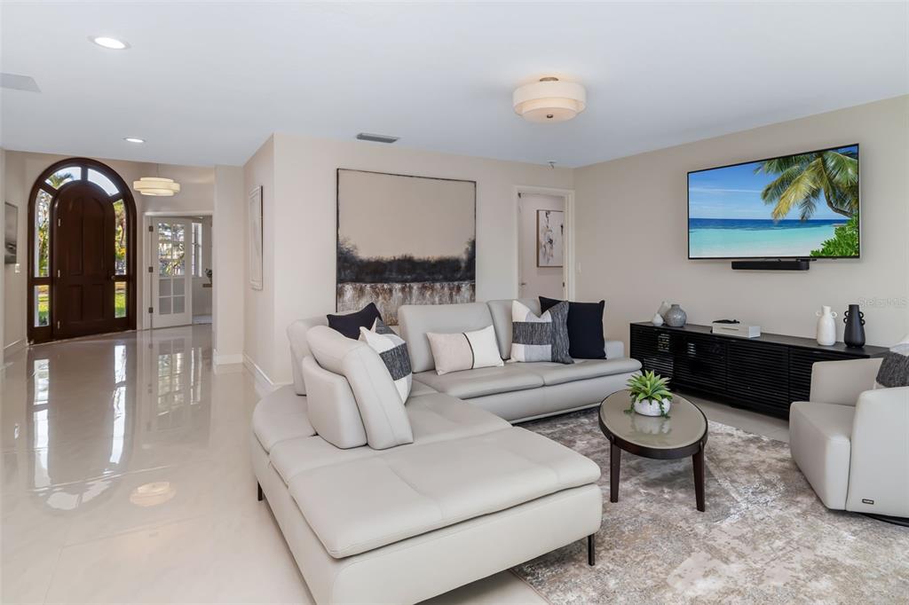 480 Cleveland Drive Sarasota, FL 34236 - Photo 9 of 95 a living room with furniture and a flat screen tv