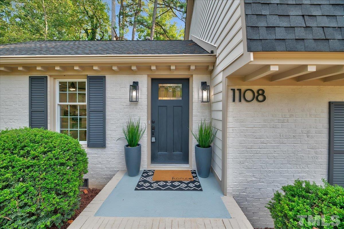 1108 East Millbrook Road Raleigh, NC 27609 - Photo 2 of 43 a front view of a house with a yard