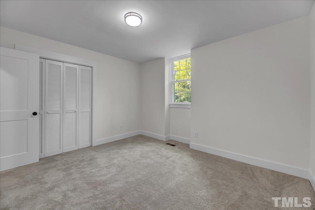 1108 East Millbrook Road Raleigh, NC 27609 - Photo 26 of 43 an empty room with a window