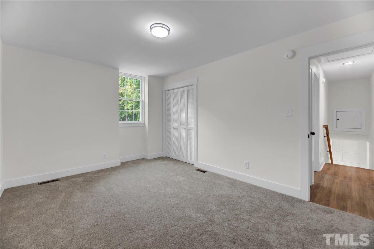 1108 East Millbrook Road Raleigh, NC 27609 - Photo 28 of 43 an empty room with windows
