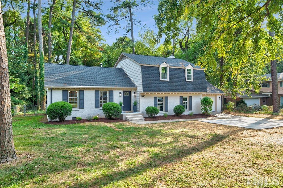 1108 East Millbrook Road Raleigh, NC 27609 - Photo 3 of 43 a view of a house with a yard