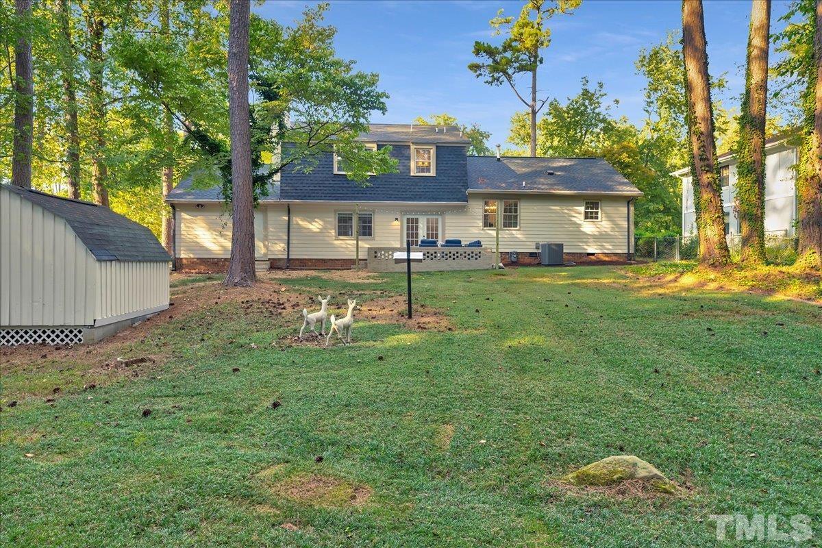 1108 East Millbrook Road Raleigh, NC 27609 - Photo 35 of 43 a view of a big house with a big yard and large trees