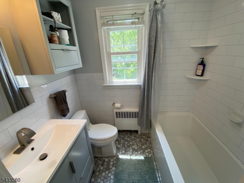 390 Morris Avenue, Unit 4 Summit, NJ 07901 - Photo 5 of 11 a bathroom with a sink toilet and shower