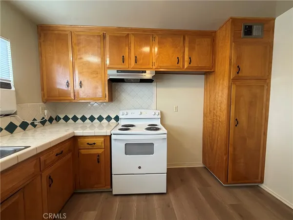 a kitchen with a sink and a stove top oven