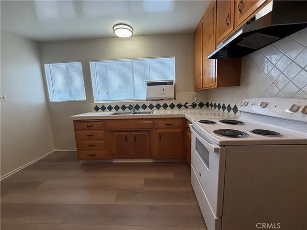a kitchen with a stove top oven sink and cabinets