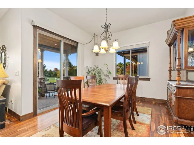 a view of a dining room with furniture a chandelier and wooden floor