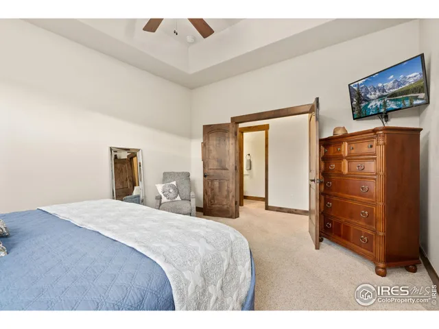 a bedroom with a bed and a television