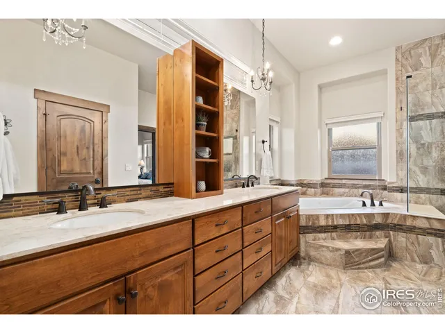 a bathroom with a tub sink and double vanity