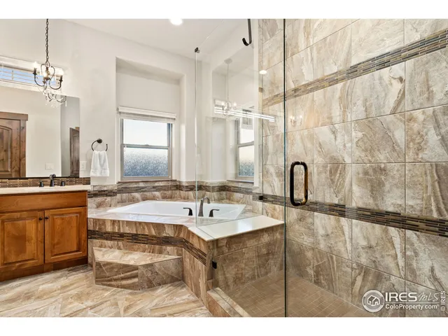 a bathroom with a sink mirror and a bath tub