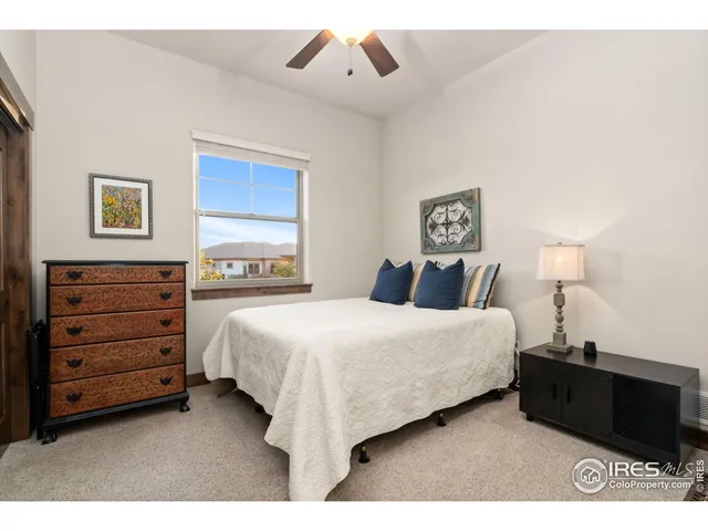 a bedroom with a bed and a night stand