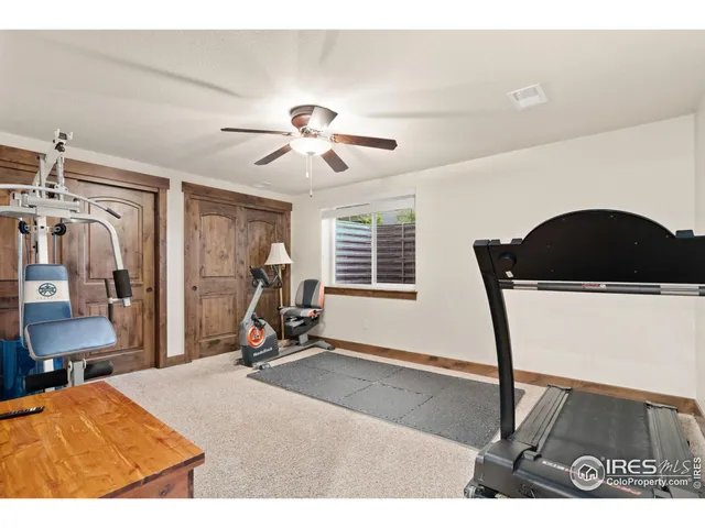 a bedroom with furniture and a gym cycle
