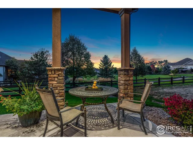 a view of a table and chairs in patio with a garden
