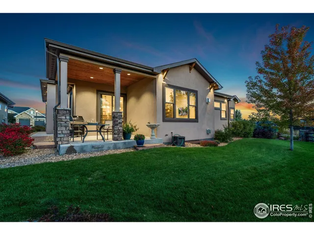 a backyard of a house with table and chairs