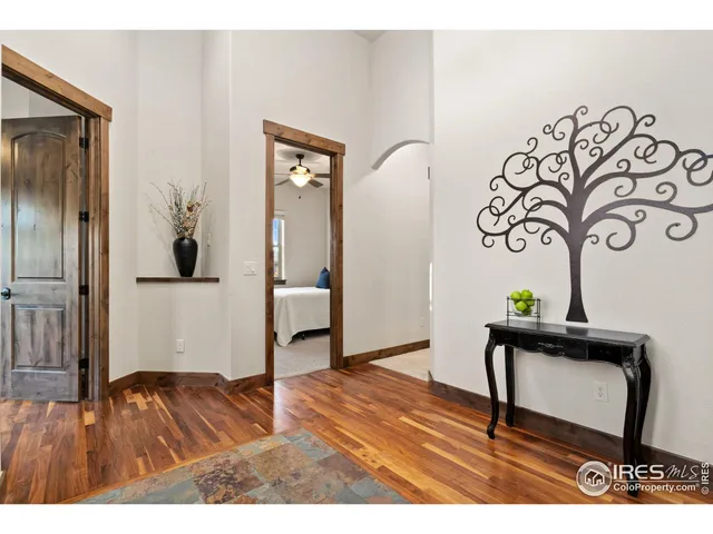 a living room with a table and paintings on the wall