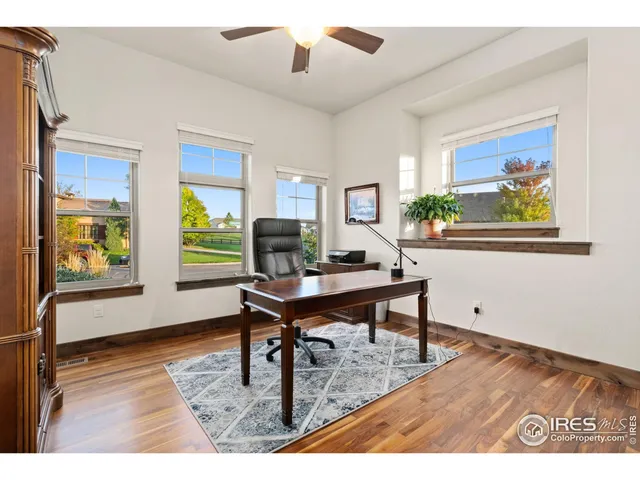a workspace with furniture window and wooden floor