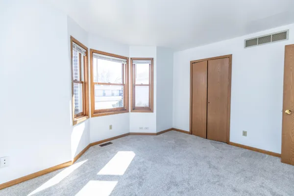 a view of room with window and a ceiling fan