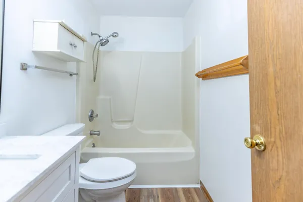 a bathroom with a toilet and a shower