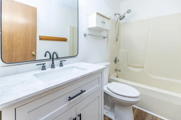 a bathroom with a sink a mirror and a shower