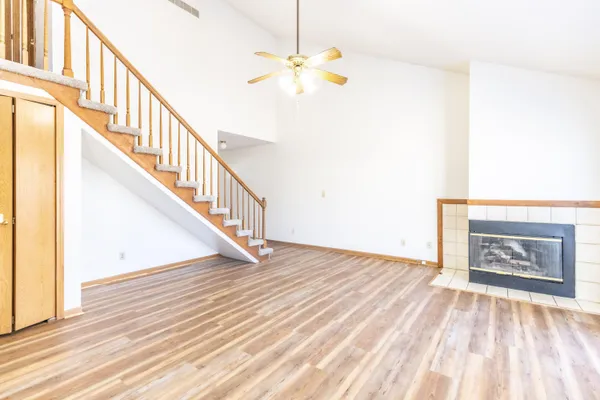 a view of entryway and hall with wooden floor