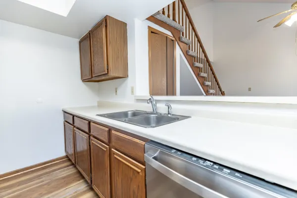 a kitchen with a sink cabinets and wooden floor