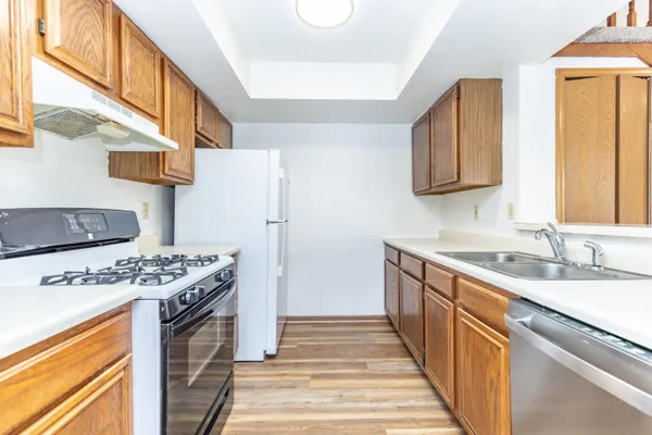 a stove top oven sitting inside of a kitchen