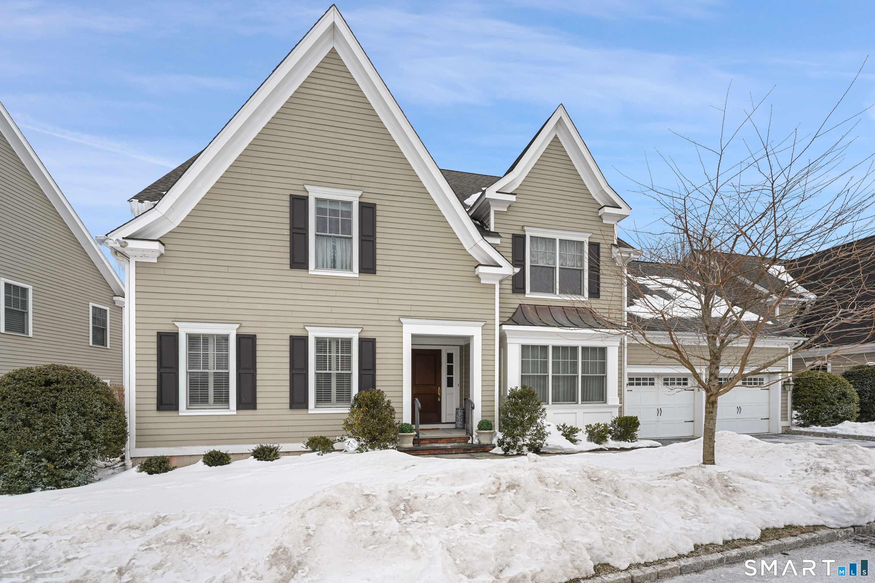 53 Waterview Way, Unit 53 Stamford, CT 06902 - Photo 1 of 1 a front view of a house with a yard covered in snow
